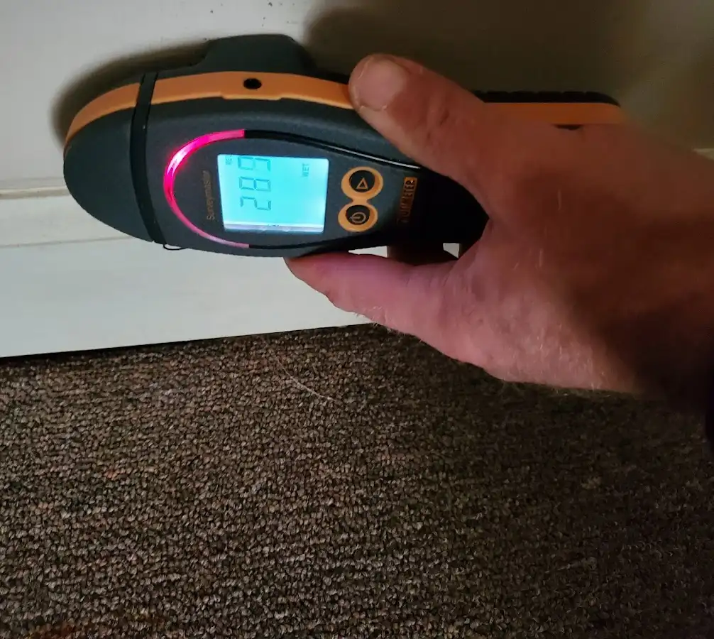 Moisture detection at baseboard during Storm Damage Restoration in Choctaw